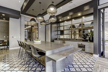 Resident social lounge with chef's kitchen, fire place & tvs